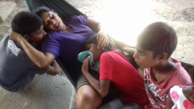 Indrawattie Chandradeo and her two remaining sons and her only daughter in tears at their home yesterday 