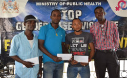  Petra Organization representative Mark Alleyne (right) poses with members from the competing teams of North East La Penitence (left), Broad Street (2nd left) and Tucville (2nd right) following the conclusion of the presentation ceremony yesterday.