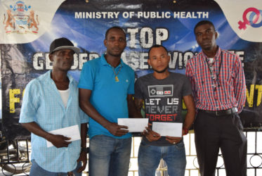  Petra Organization representative Mark Alleyne (right) poses with members from the competing teams of North East La Penitence (left), Broad Street (2nd left) and Tucville (2nd right) following the conclusion of the presentation ceremony yesterday. 