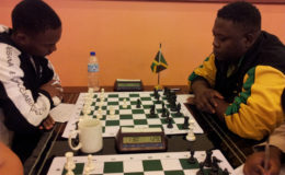 Guyana's national chess player Anthony Drayton (left) opposes a Jamaican colleague during the 2014 FIDE-sponsored Umada Cup which was held here. Drayton had just returned from the 2014 Chess Olympiad in Tromso, Norway, where he achieved the coveted Candidate Master title. He is representing Guyana at the 2016 Chess Olympiad in September in Baku, Azerbaijan where he will seek additional honours on behalf of himself and his country and himself. 