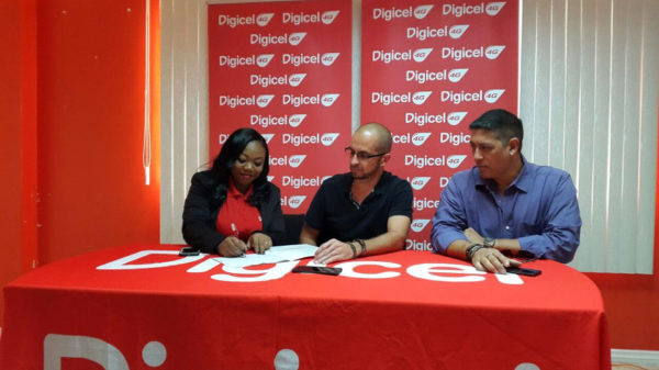 Digicel Senior Sponsorship Manager Louanna Abrams inking the agreement as Team Evolution’s President Keith Fernandes (centre) and Secretary Andrew Arjoon look on.