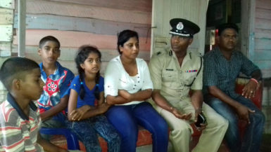 Commander of ‘B’ Division Ian Amsterdam (second, right) meeting with Pawan Chandradeo’s wife and children 
