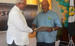 Minister of Agriculture Noel Holder (left) congratulating one of the awardees. (GINA photo)