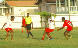 Action between Lodge Secondary (white) and Brickdam Secondary in the Digicel Schools Football Championship at the Tucville ground. (See story on page 27) 