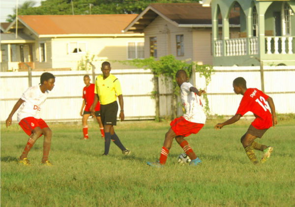 Action between Lodge Secondary (white) and Brickdam Secondary in the Digicel Schools Football Championship at the Tucville ground. (See story on page 27) 
