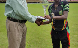 MVP Shemaine Campbelle accepts her MVP trophy from Match
Referee Grantley Culbard.