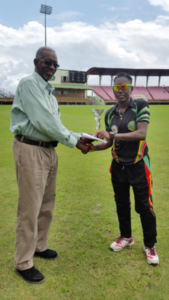 MVP Shemaine Campbelle accepts her MVP trophy from Match Referee Grantley Culbard.