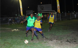 Jimmy Gravesande of Broad Street (right/yellow) attempts to challenge Tucville’s Delon Williams during their semi-final encounter in the Ministry of Health/Petra Organization Soft Shoe Championship at the Santos Training Area yesterday.