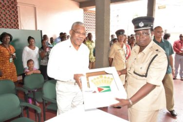 President David Granger being presented with a cake by a member of the Guyana Police Force as part of his 71st birthday celebrations yesterday. (Ministry of the Presidency Photo) 
