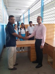 Rotary Club of Stabroek President Anand Harrilall (right) making the donation to St. Joseph’s High School Principal Nathram Raghubansi. (Rotary Club of Stabroek photo)