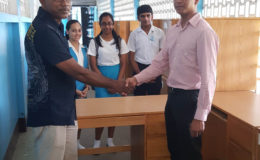 Rotary Club of Stabroek President Anand Harrilall (right) making the donation to St. Joseph’s High School Principal Nathram Raghubansi. (Rotary Club of Stabroek photo)