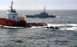 The MV Hamal in the foreground under the watchful eye of a Royal Navy vessel (NCA photo)