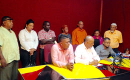 Region Five Chairman Vickchand Ramphal (seated at right) with (from left) PPP Secretary Zulfikar Mustapha and PPP General Secretary, Clement Rohee. In the background are Region Five councillors