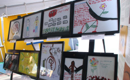Some of the exhibition’s artwork on display on the tarmac of the Brickdam Police Station yesterday.