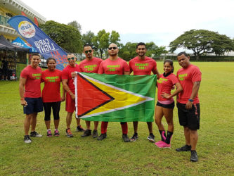 Guyana’s contingent of athletes which included: Dillon Mahadeo, Dr. Christian McRae, Ian Rogers, Jamie McDonald, Carlos Mendonca and Angelina DeAbreu from CrossFit 592, Guyana's first and only official Crossfit affiliate as well as Dr. Osmond Mack and Neesa Bhagwandin of Life Gym pose with the Golden Arrowhead.