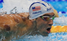 Michael Phelps of USA is seen with red cupping marks on his shoulder as he competes in the 200m butterfly preliminary. REUTERS/Dominic Ebenbichler