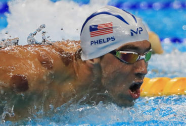 Michael Phelps of USA is seen with red cupping marks on his shoulder as he competes in the 200m butterfly preliminary. REUTERS/Dominic Ebenbichler