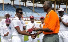 Fast bowler Alzarri Joseph receives his West Indies Test cap from fast bowling legend and team manager, Joel Garner. (Photo courtesy WICB Media) 
