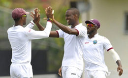 Fast bowler Miguel Cummins (centre) is congratulated by teammates after taking a wicket during the Indian innings. (Photo courtesy WICB Media) 