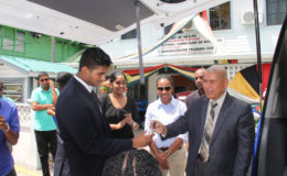 Members of Gaico handing over the keys to Minister George Norton as other employees of Gaico & NCD look on.