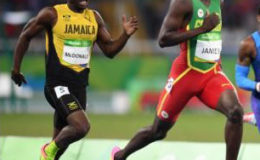 Jamaica’s Rusheen McDonald chasing Grenada’s Kirani James in the heats of the men’s 400 metres (Jamaica Gleaner photo)