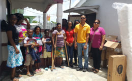 Geeta Boodhoo and three of her children with members of the Rotary and Rotaract Clubs of Stabroek