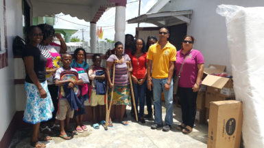 Geeta Boodhoo and three of her children with members of the Rotary and Rotaract Clubs of Stabroek