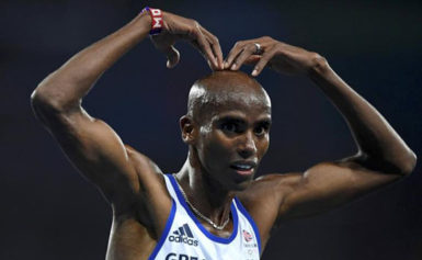 Mo Farah of Britain celebrates after winning the race. (REUTERS/Dylan Martinez)