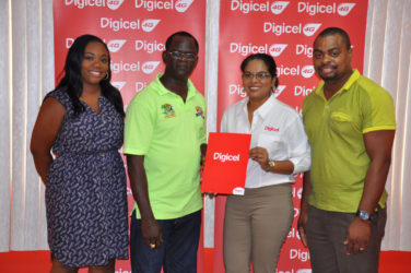 Digicel’s Communications Manager, Vidya Sanichara hands over the company’s pact to Chairman of the Boyce and Jefford Committee, Colin Boyce, as Co-Chairman, Edison Jefford (right) and Digicel’s Events and Sponsorship Executive, Louanna Abrams (left) look on.