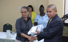 Lead Consultant Paula Trotter hands over the Assessment Reports of the five newly accredited Baby Friendly hospitals to Minister of Public Health Dr George Norton.
