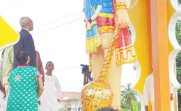 President David Granger looks up at the almost 15 ft murti of Lord Hanuman at the Blairmont Mandir yesterday morning. (Ministry of the Presidency photo)
