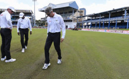 Match officials inspect the outfield before calling off play at Queen’s Park Oval yesterday. (Photo courtesy WICB Media)