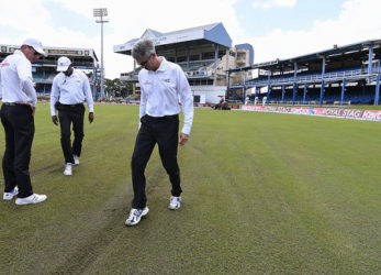 Match officials inspect the outfield before calling off play at Queen’s Park Oval yesterday. (Photo courtesy WICB Media)  