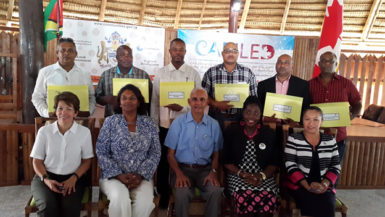 From left seated: Marion Villanueva, Project Director, CARILED;  Sharmini Poulin, Chargé d’ Affaires, High Commission of  Canada; Ronald Bulkan, Minister of Communities and junior ministers Valerie Patterson and  Dawn Hastings-Williams; pose with representatives from the six local authorities who signed MoUs,  at the Umana Yana, Georgetown.