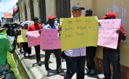 General Secretary of the PPP Clement Rohee with protesters outside the High Court yesterday
