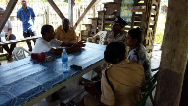 Commander of ‘B’ Division Ian Amsterdam (third, right) and other police officers meeting with Akeem Grimmond’s parents at their home.