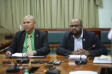Public Health Minister Dr George Norton (at left) with Director of Public Information Imran Khan as he faces the press 