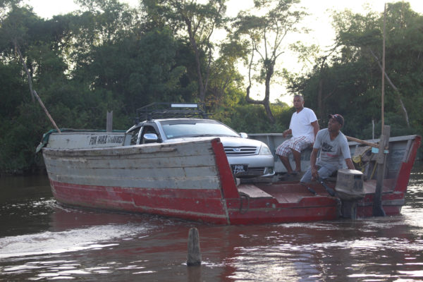 What if you miss the ferry? A speedboat will do. This car managed the Essequibo crossing between Supenaam and Parika in a speedboat. (Photo by Joanna Dhanraj) 