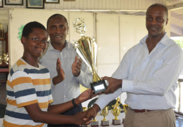 Jordan Nelson receives his trophy for best student from Permanent Secretary Alfred King. 