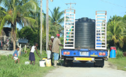 ne household presented several buckets to be filled as the GWI contracted truck made its way through the street.
