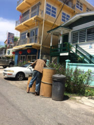 A vagrant going through garbage placed on the road side in Alberttown 