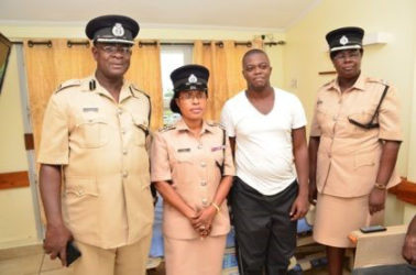 From left, Assistant Commissioner of Operations Christopher Griffith, Deputy Superintendent of Police and Welfare Officer of the GPF Loreine Saul and DSM Maxine Graham with Victor Faucette (second from right) in his hospital room. (GINA photo) 