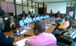 Seated at left are the eight students with GCAA Director Chaitrani Heeralall, while at the head of the table is GCAA Director-General Egbert Field. To his right (backing camera) is Human Resource Officer Derrick Johan and seated at right are the guarantors of the students. 