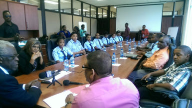 Seated at left are the eight students with GCAA Director Chaitrani Heeralall, while at the head of the table is GCAA Director-General Egbert Field. To his right (backing camera) is Human Resource Officer Derrick Johan and seated at right are the guarantors of the students. 