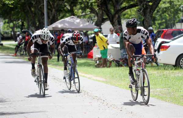 Michael Anthony (far right) leading his teammates across the finish line to complete a Team Evolution sweep yesterday at the National Park. (Orlando Charles photo)
