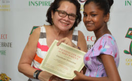 First Lady Sandra Granger yesterday attended the Science, Technology, Engineering and Mathematics (STEM) Guyana Graduation Ceremony at the National Sports Resource Centre on Woolford Avenue and said she was encouraged by the interest that the Lego Robotics Building and Programming Workshop has generated in young people. In this Ministry of the Presidency photo, the First Lady presents a Certificate of Achievement to Chandroutie Gooberdhan, one of the graduates from the workshop held at the Lusignan-good Hope Learning Centre, Lusignan, East Coast Demerara. 