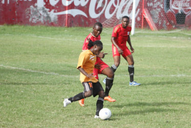 Jason Williams (left) of Camptown FC battling to maintain possession of the ball while being challenged by a GPF player during their matchup in the Mayor’s Cup Football Championship at the GFC ground. (Orlando Charles photo) 