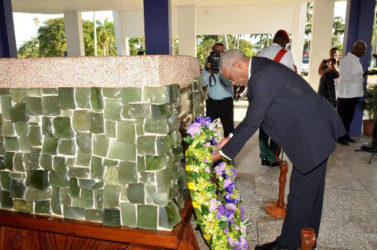 President David Granger lays a wreath at the Mausoleum in the Botanical Gardens. (Ministry of the Presidency photo)