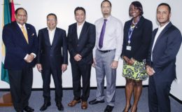 Prime Minister Moses Nagamootoo (left) and Head of Go-Invest, Owen Verwey with the HGS officials and Go-Invest official Uchenna Gibson (second from right)  (Office of the Prime Minister photo)