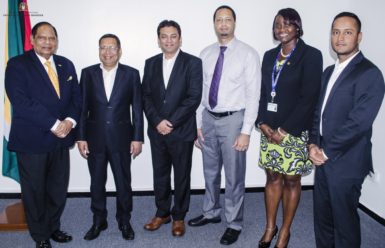 Prime Minister Moses Nagamootoo (left) and Head of Go-Invest, Owen Verwey with the HGS officials and Go-Invest official Uchenna Gibson (second from right)  (Office of the Prime Minister photo)